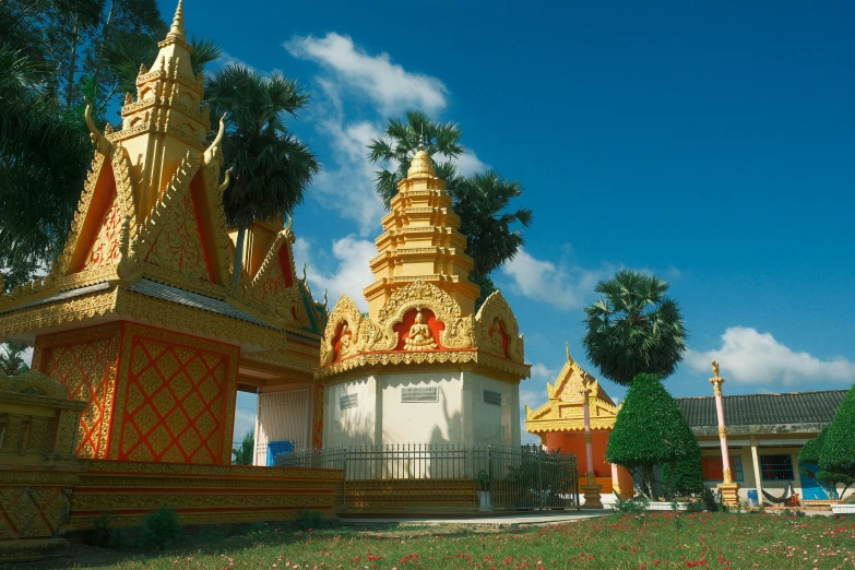 many gold and white architecture with trees in the background