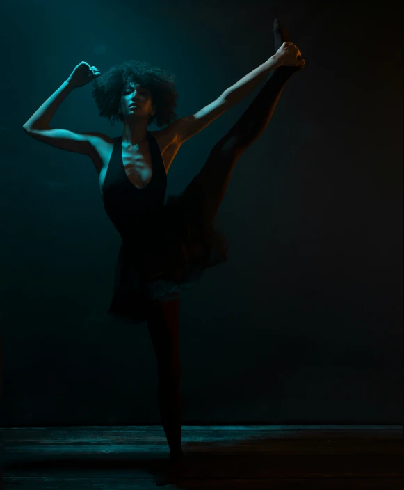 a woman that is dancing in the dark