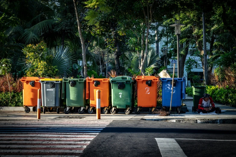 a number of waste bins on the road