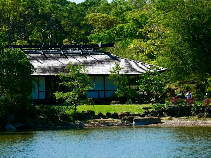 an image of people near a house on the water