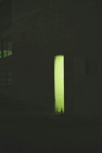 a door illuminated with bright green light shining through