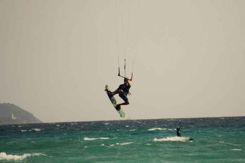 a para - sailor is in the air above an ocean