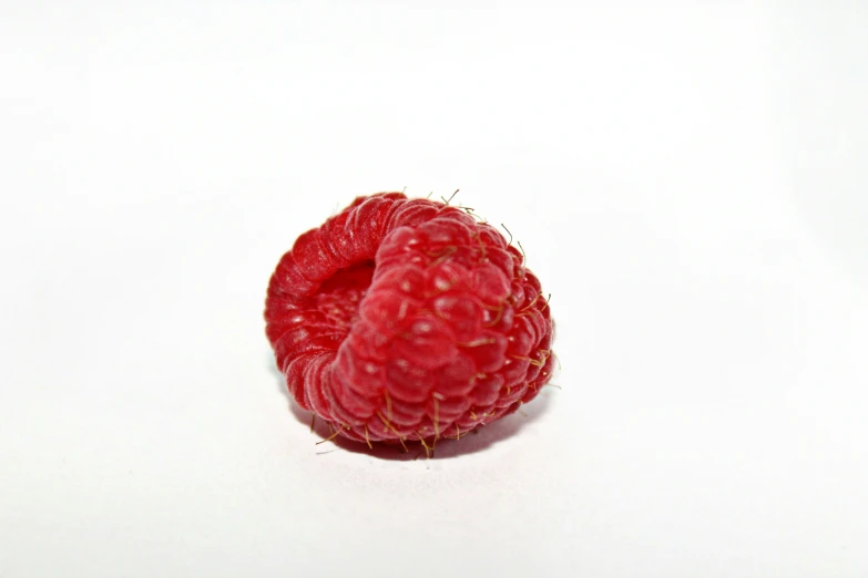 a raspberry with the middle half bitten