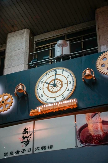 a clock with an ornamental clock face hangs from a building