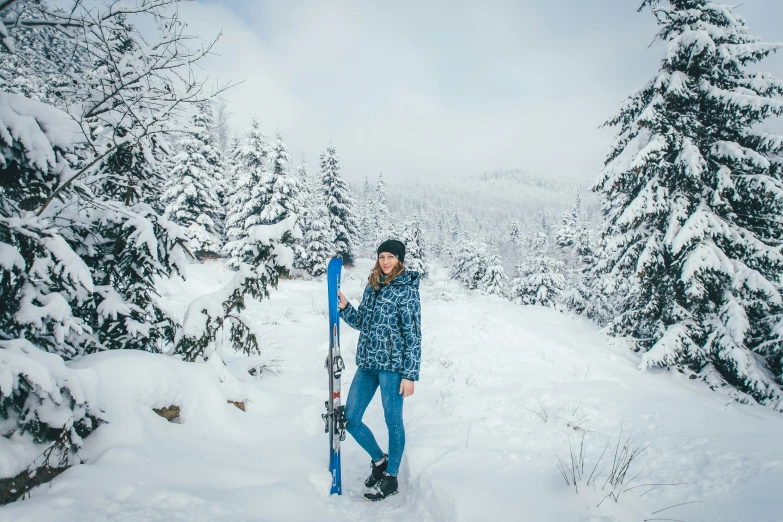 this is a person holding a ski board in the snow