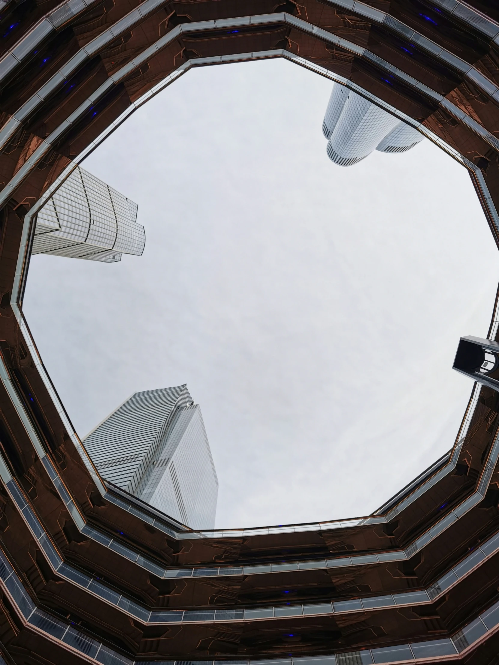 a circle view looking up at tall buildings in the middle