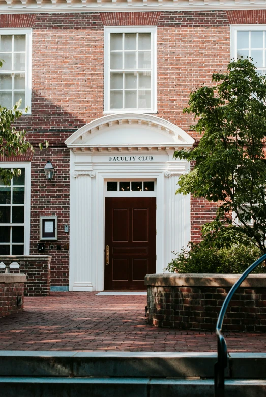 front view of a brick building with a clock on it