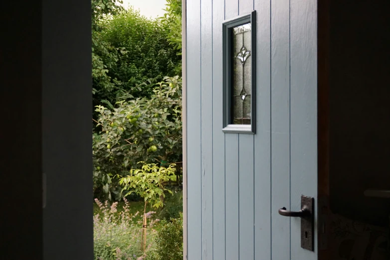 an open door with a clock on the wall in front of it