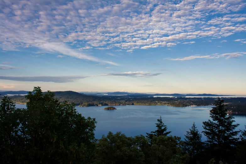 the sky is filled with clouds over the water