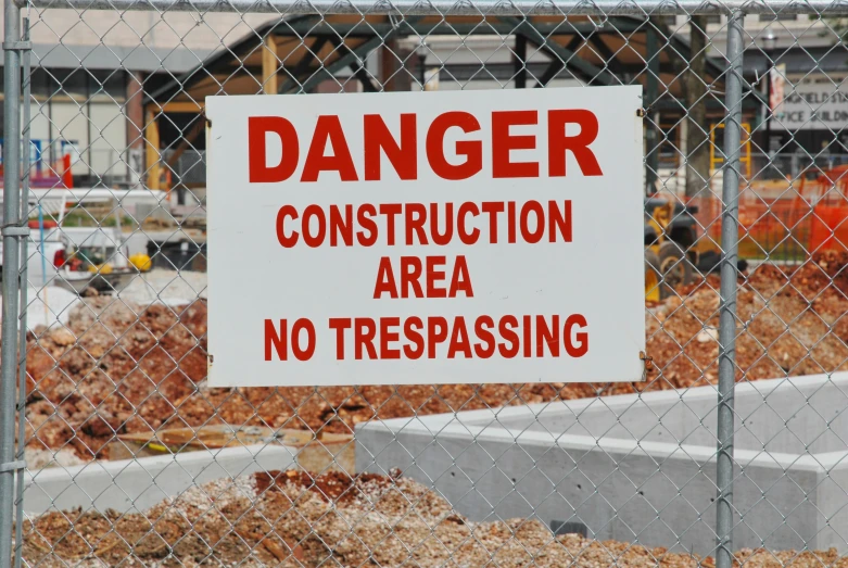 a construction area sign with a construction behind it