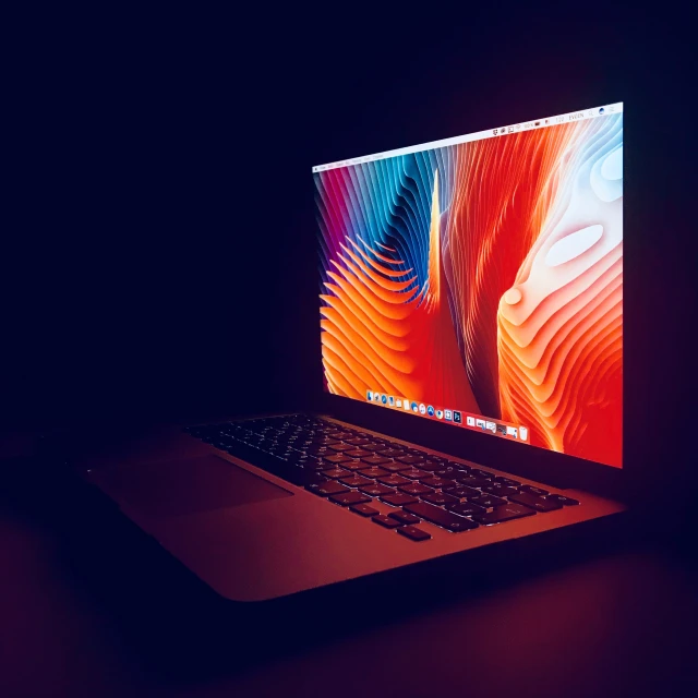 apple macbook pro on display in a dark spot