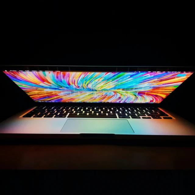 a laptop with brightly colored screens lit up