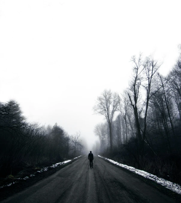 the lone person is standing alone on the road