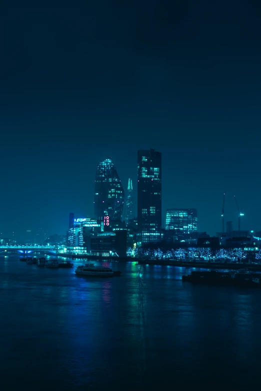 a city lit up at night, reflecting lights on the water