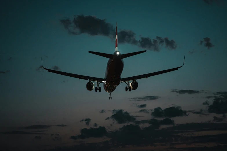 an airplane flying into the sky at night