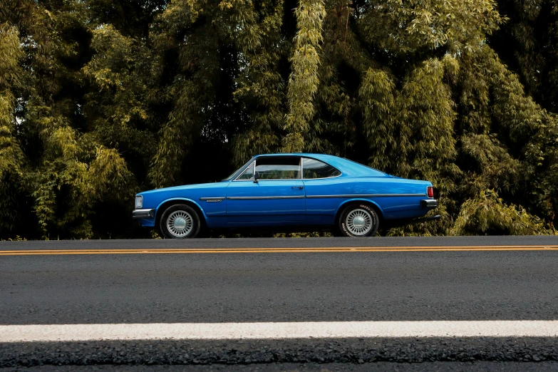 a blue car parked on the side of a road