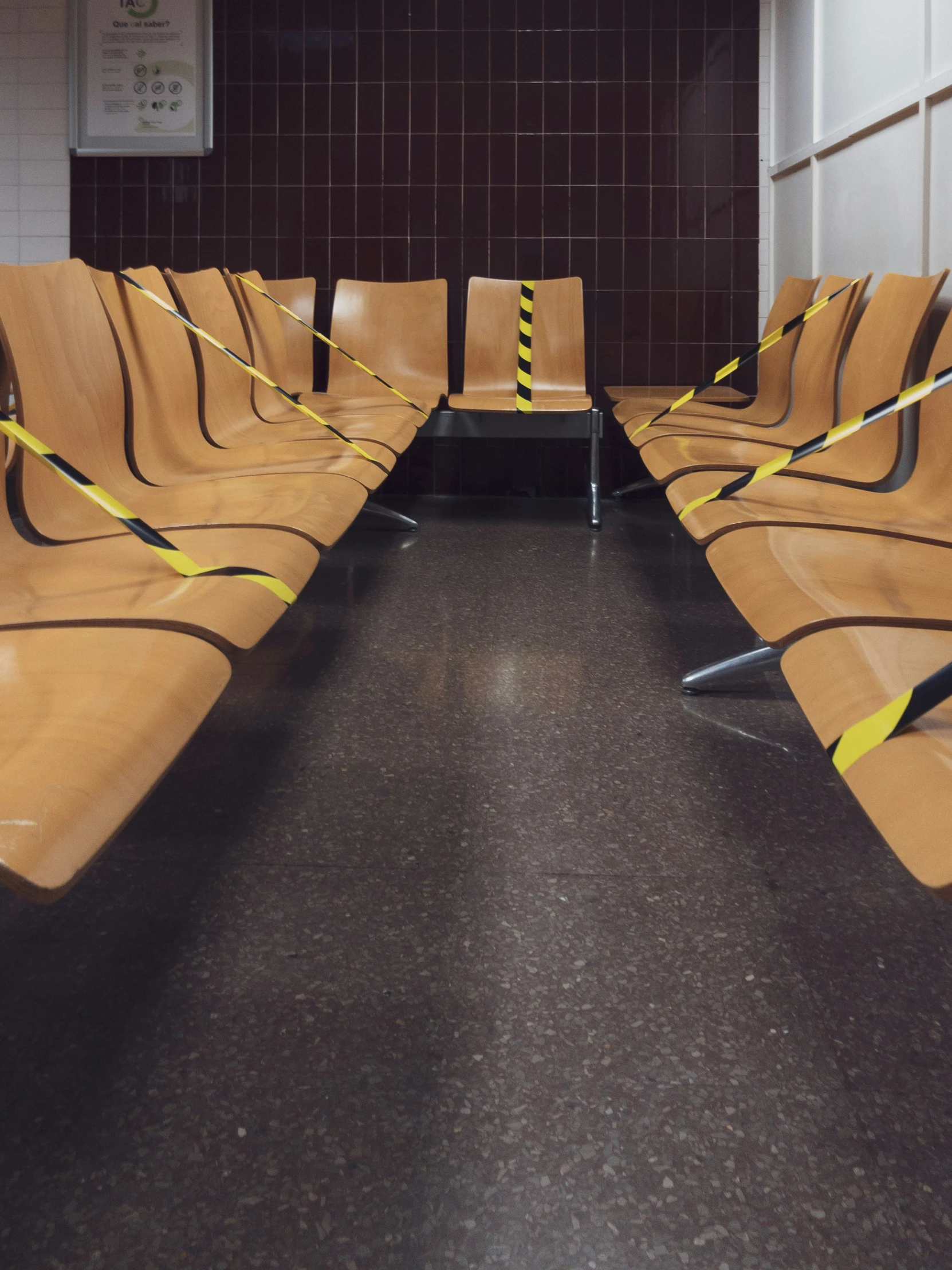 rows of chairs are taped up next to each other