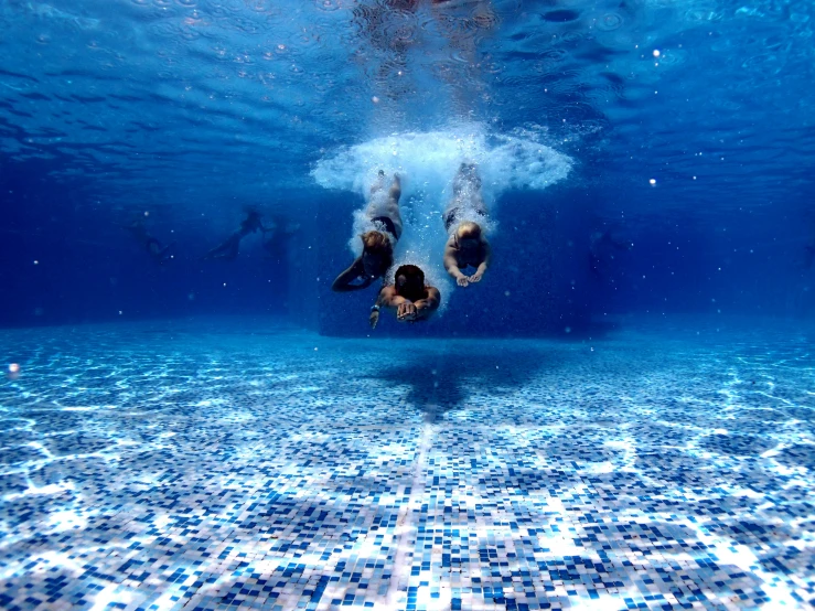 two people swimming in the clear blue ocean