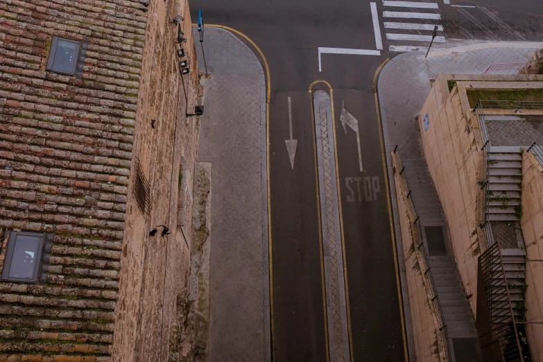 the view of a street with traffic signs and traffic signals on it