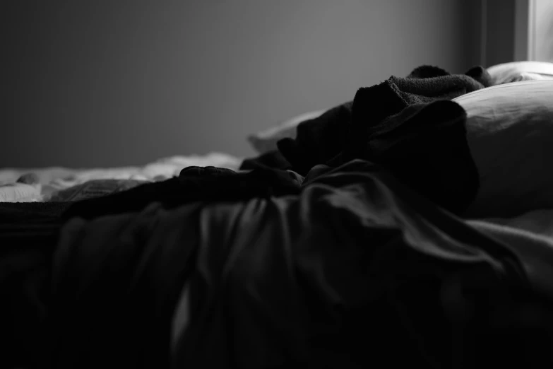 a bed with black and white covers is shown
