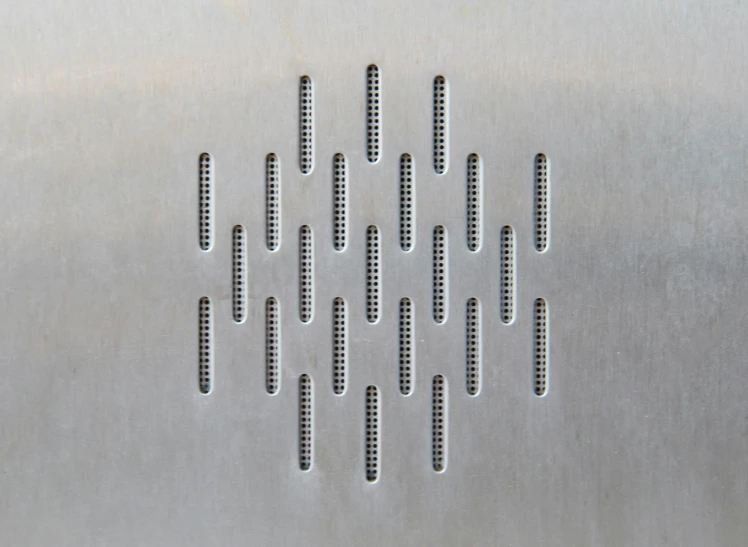 a metal structure with different shaped holes and strips in it