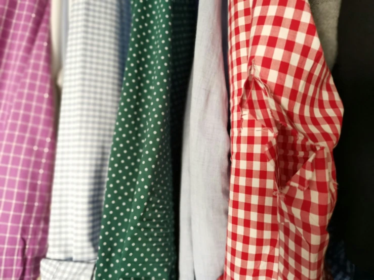 the ties are lined up on a coat rack