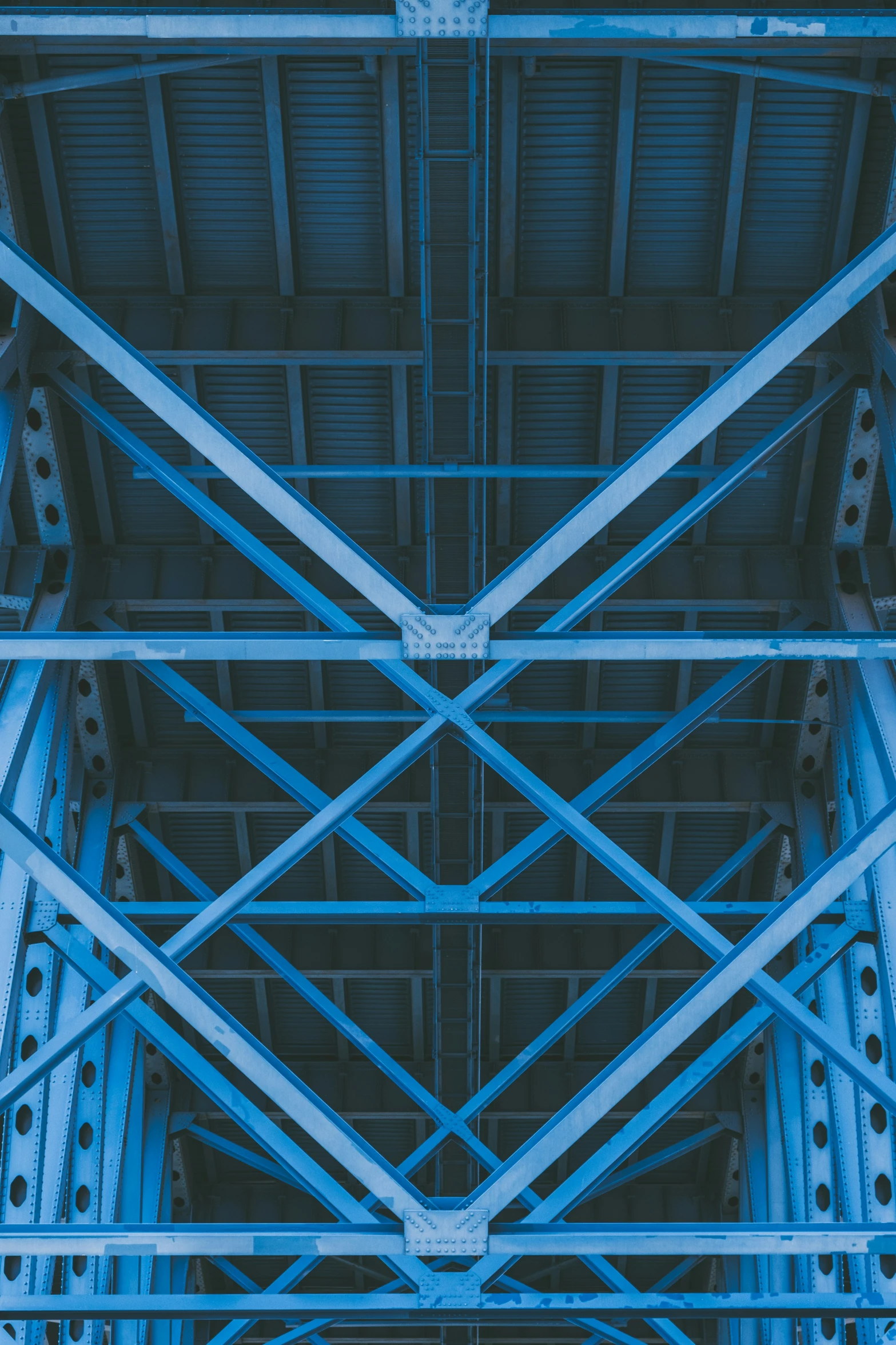 inside an elevated metal structure with blue paint