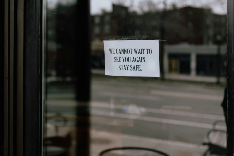 a warning sign is posted in the window of a business