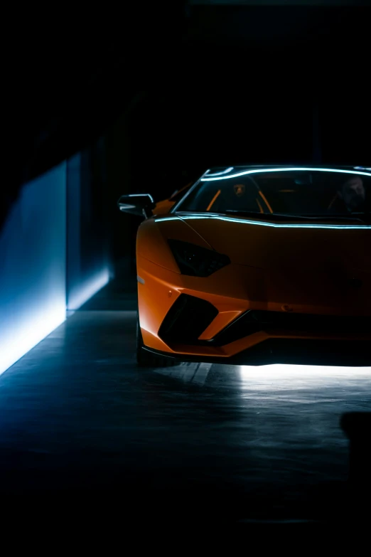 a po of an orange sports car in the dark