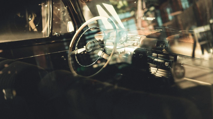 a vehicle is seen with its reflection in the glass