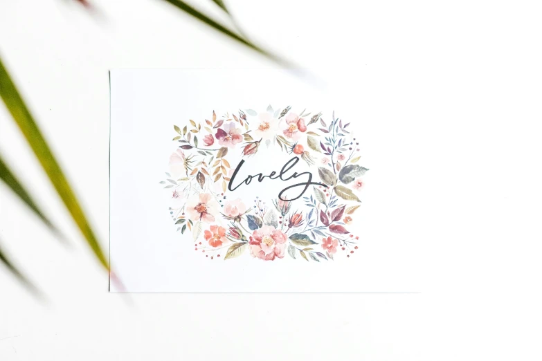 an illustrated card featuring the words love surrounded by flowers
