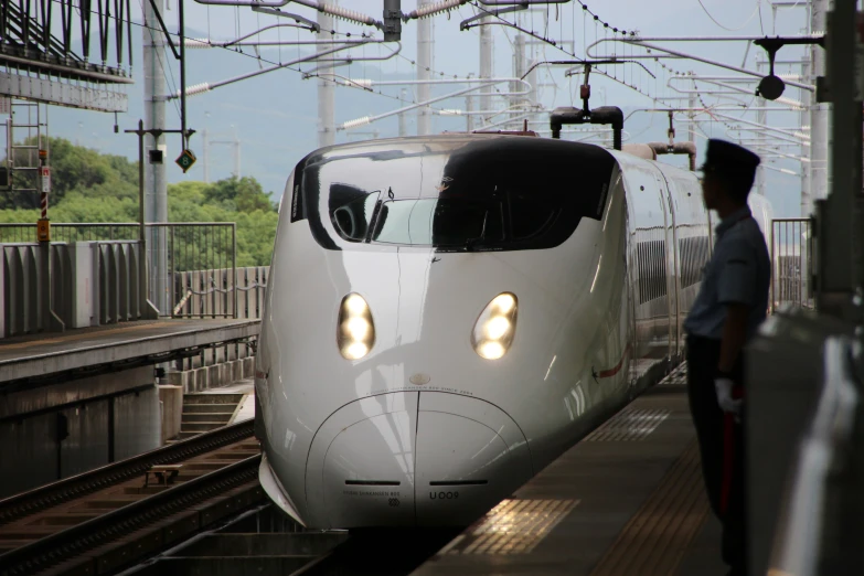 a train at the station with one person nearby