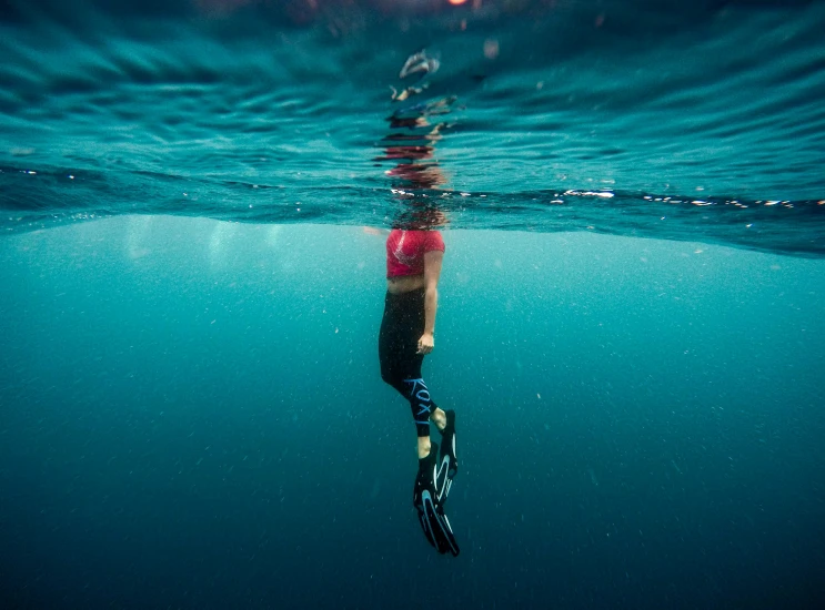 the water was clear and blue as a person skis near by