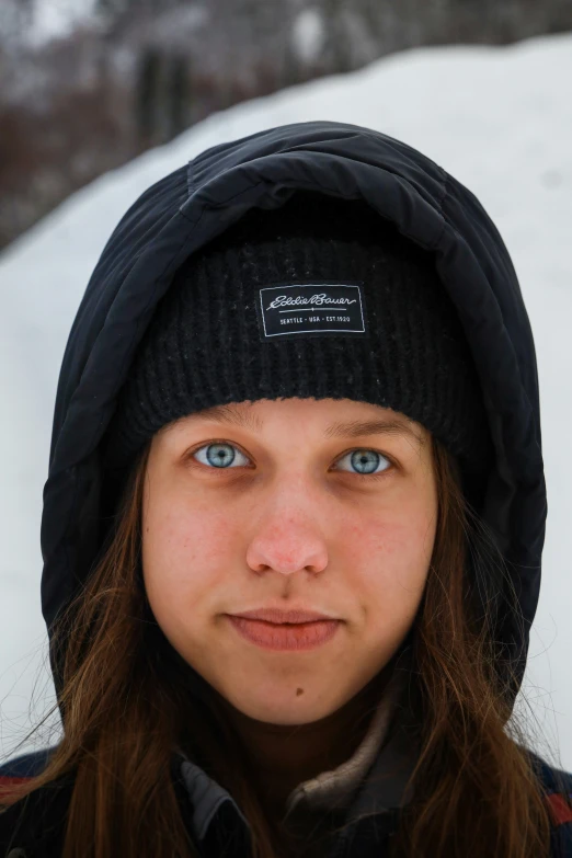 a young woman wearing a beanie with the word on it