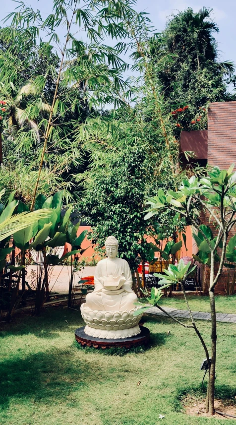 a small stone statue sitting on a lush green field