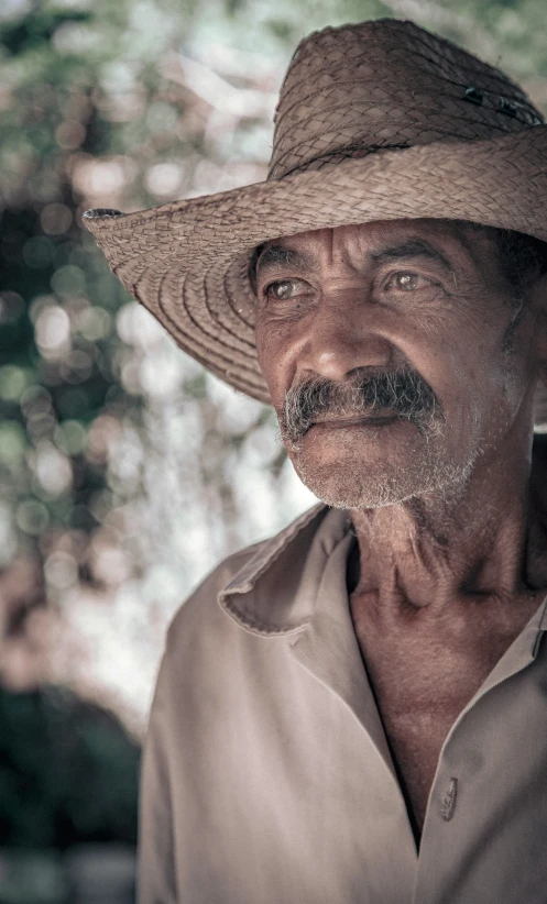 an old man wearing a large straw hat