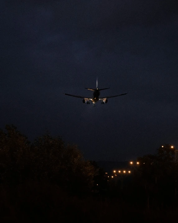 a plane flying in the sky above the ground