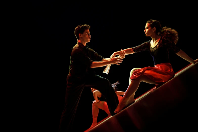 a man and a woman dance on a staircase