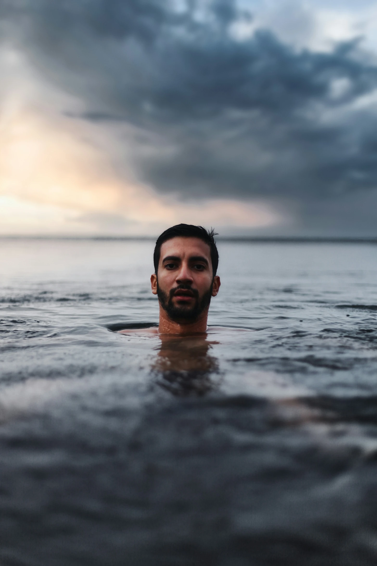 man with beard in middle of body in water