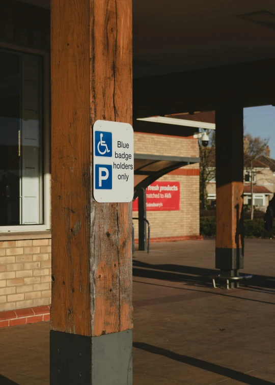 a handicapped sign is on a wooden pole