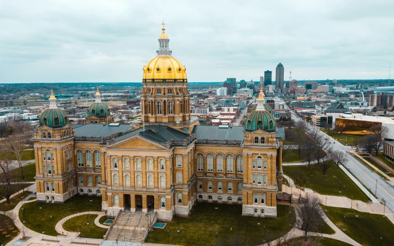 large old city building with yellow dome next to road