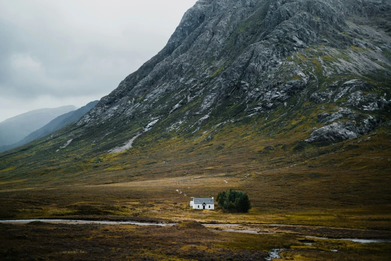 a small mountain with a house by it