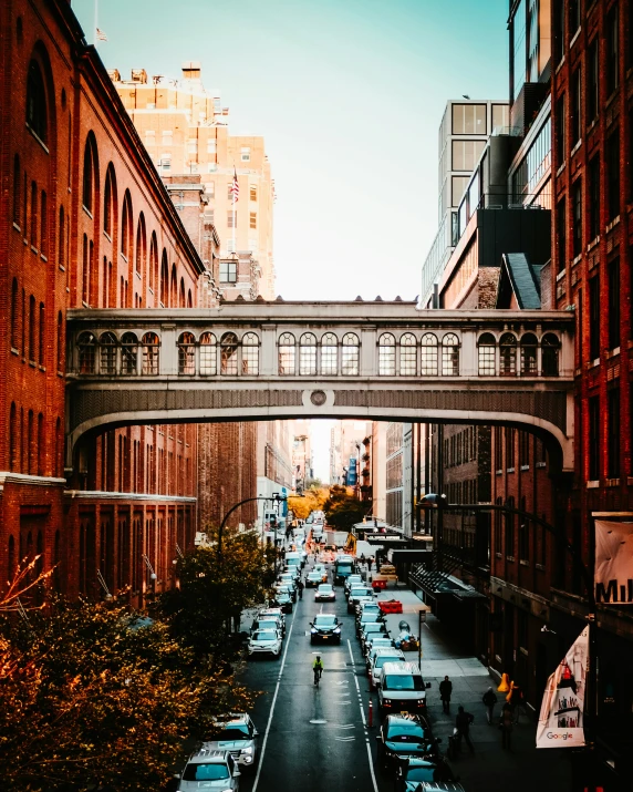 a view of some street with cars going under a bridge