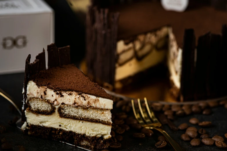 a piece of cake sits next to coffee beans