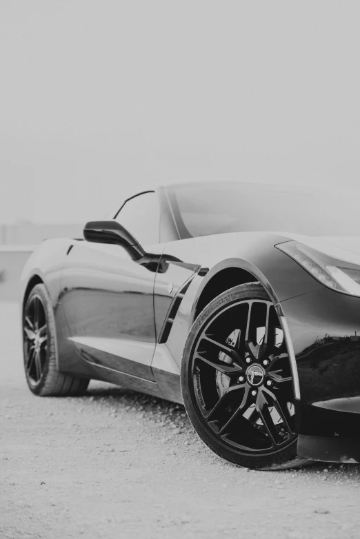 a black and white picture of the wheels of a supercar
