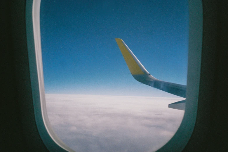 an airplane window, wing and the wing of it