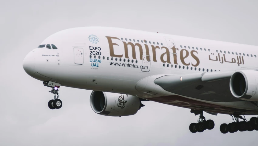 an emirates airplane is ascending in the air