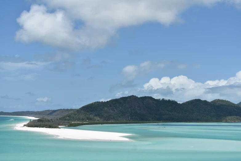 the large island is sitting under some clouds