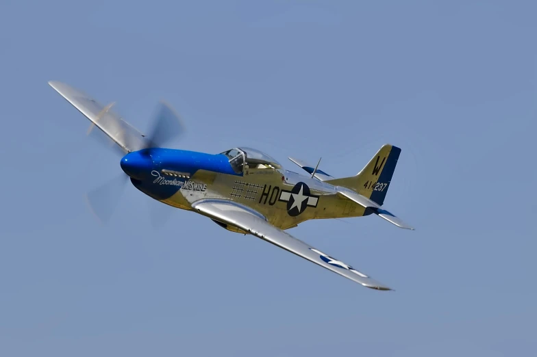 an older world war ii airplane flying in the sky