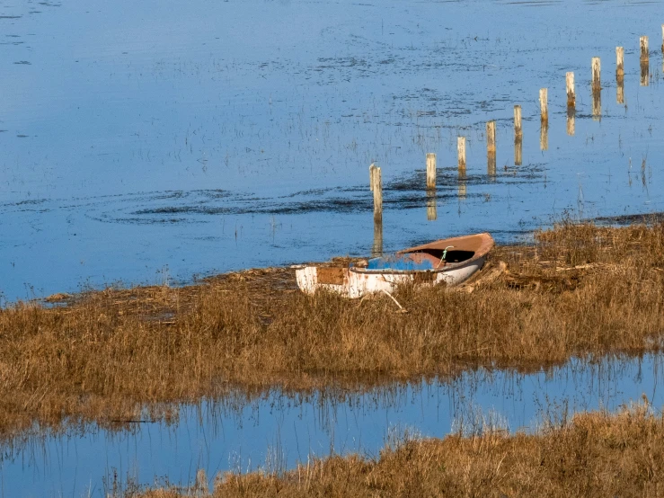 the boat is left on the shore of the lake